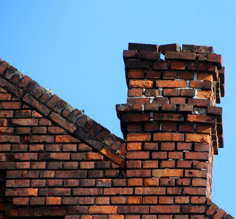 Signs Your Beverly Home Needs a Chimney Inspection Damaged chimney on an Beverly home showing cracks and missing mortar